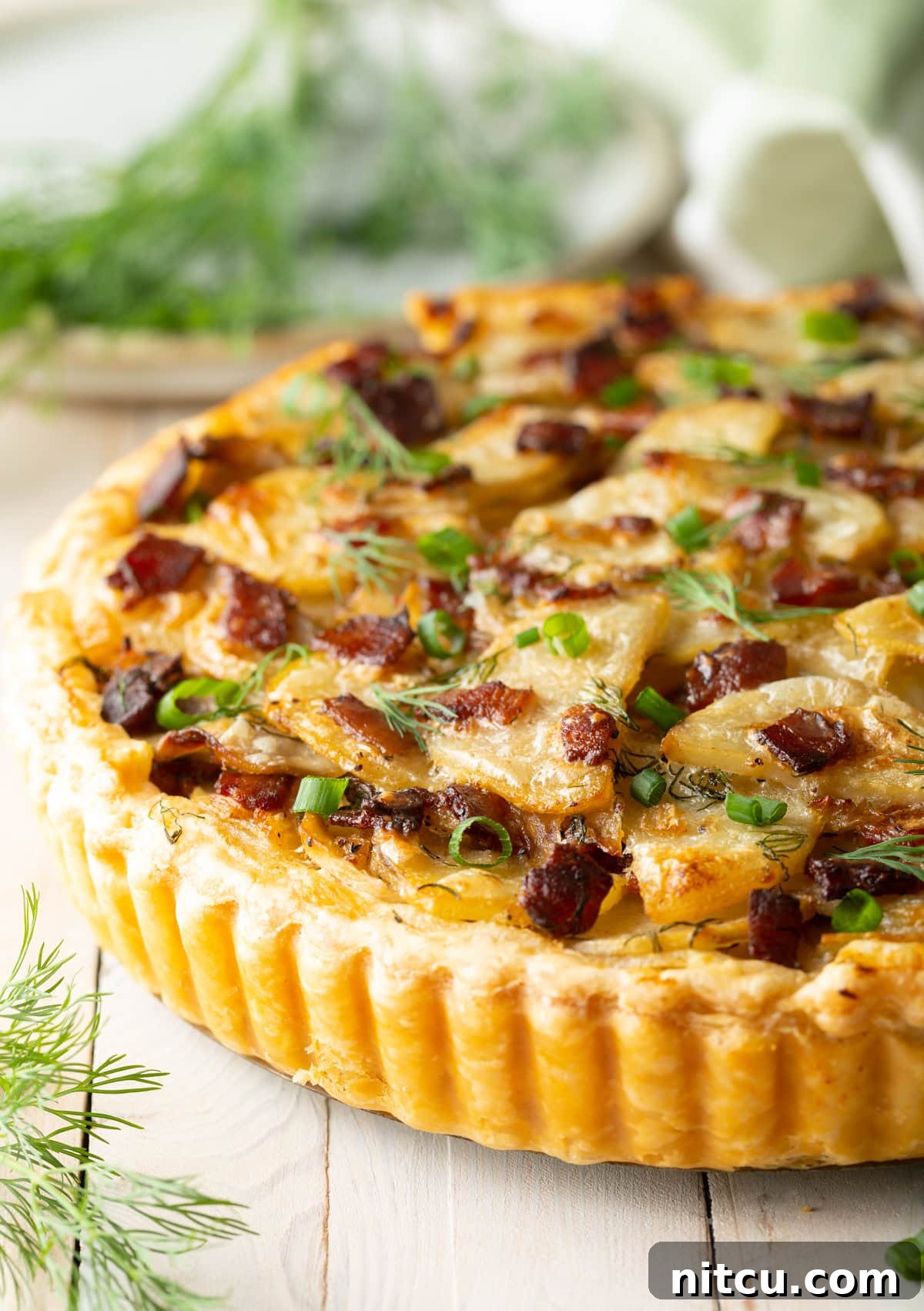 A delicious side view of the baked Irish potato tart, revealing its layers of potatoes and golden crust.