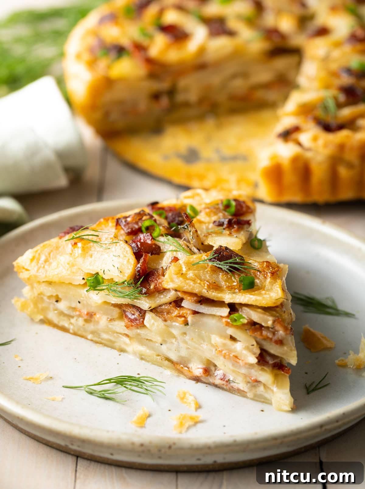 A generous slice of Irish potato pie on a plate, ready to be enjoyed, showing off its layered texture.