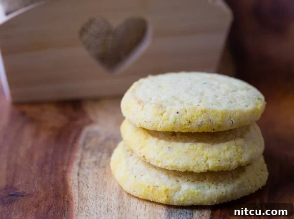 Cornmeal cookies stacked on top of each other, ready to be enjoyed.