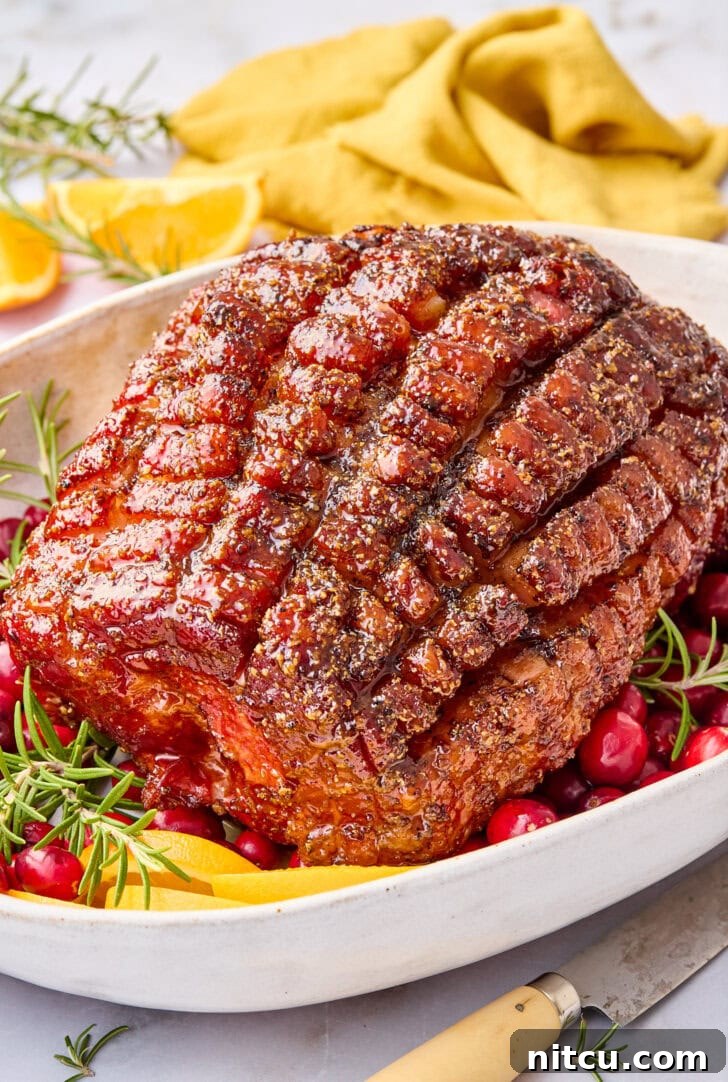 A glorious brown sugar glazed Thanksgiving ham, just out of the oven, served on a grand platter with festive garnishes, showcasing its dark, caramelized crust and succulent appearance.