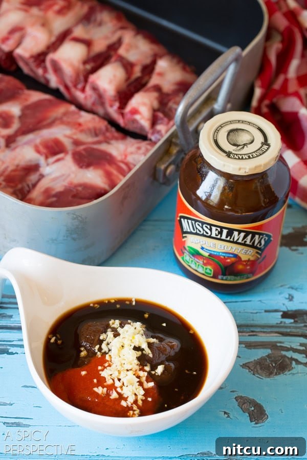 Closeup view of ramekin filled with Musselman's apple butter, garlic, Sriracha, soy sauce and fish sauce. 