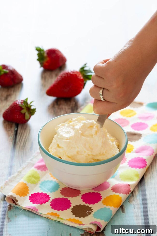 Kid-Friendly Fruit Pizza for Breakfast featuring a creamy white spread, ready for fruit toppings.