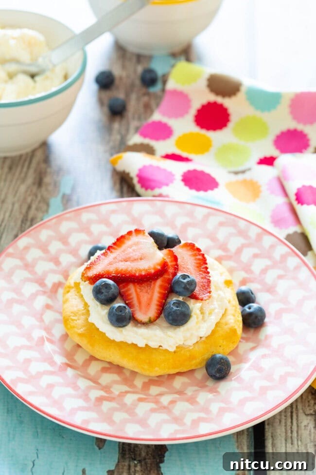 A single simple breakfast fruit pizza served on a plate, showcasing its vibrant toppings.