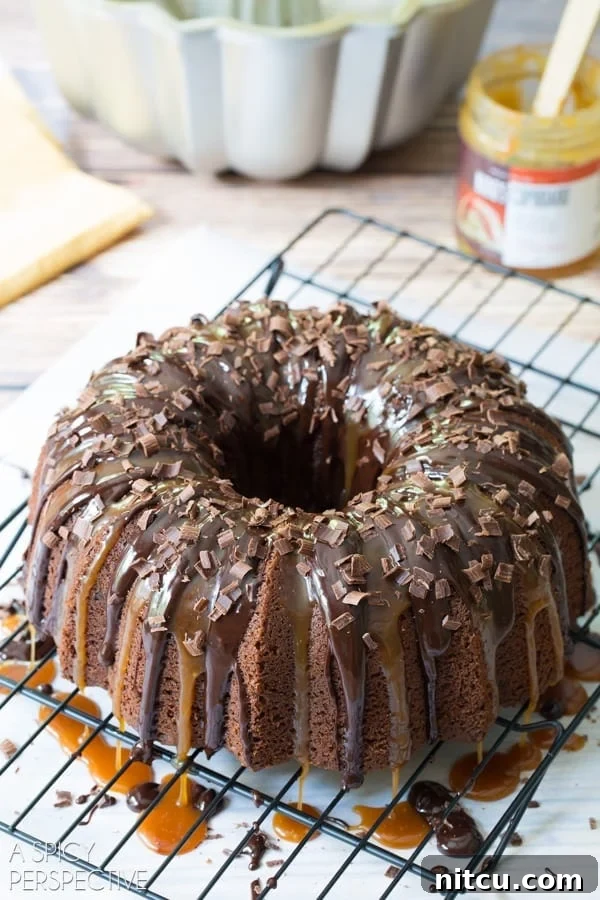 A decorative Baileys Irish Cream Bundt Cake adorned with delicate chocolate shavings, highlighting its rich texture and enticing aroma.