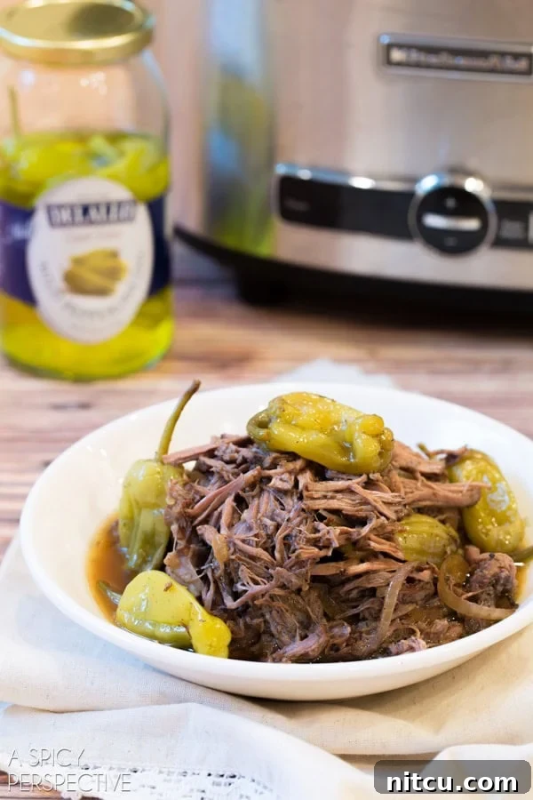 Easy Crockpot Italian Beef Recipe served on a plate with various toppings