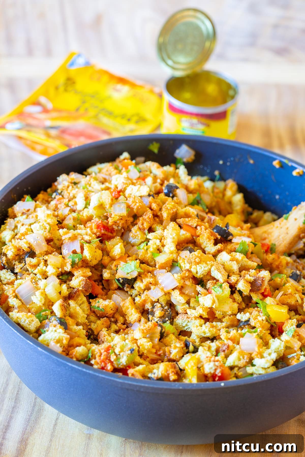 Southern cornbread dressing ingredients with green chiles arranged around a skillet, ready for preparation