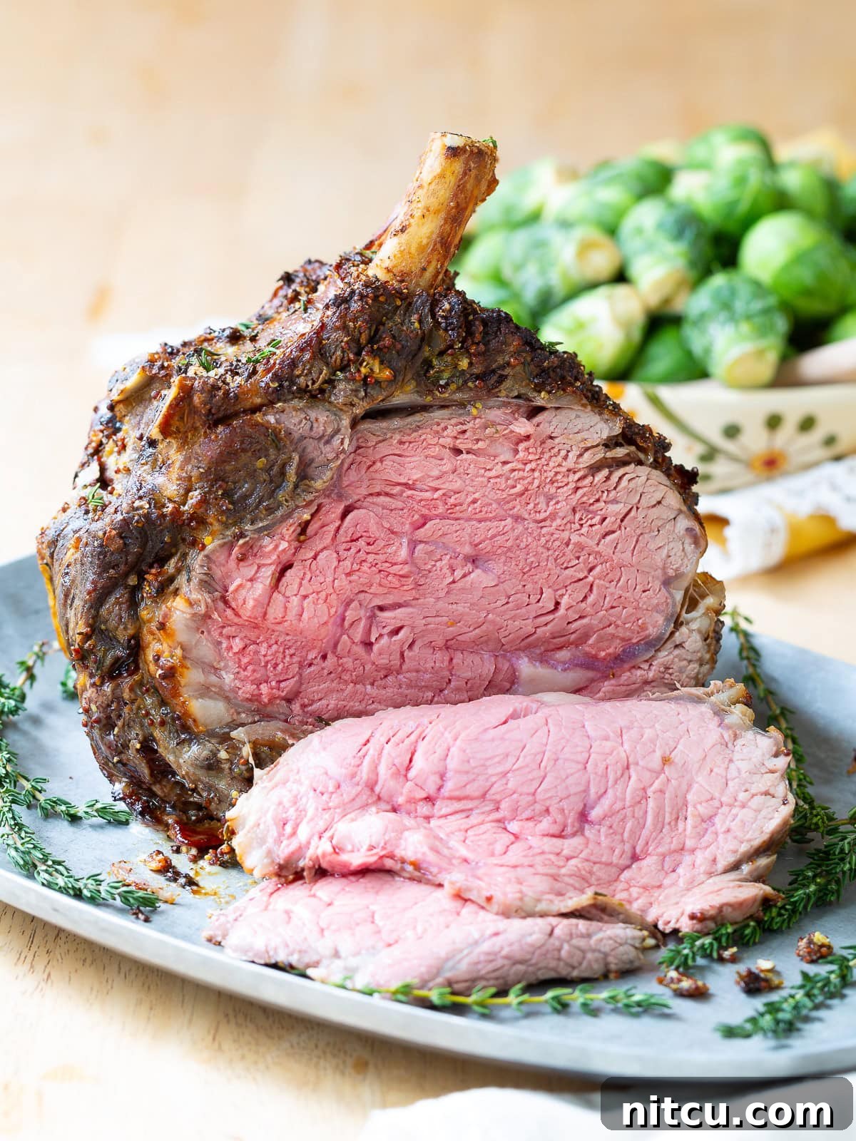 Close-up side view of several slices of prime rib, showcasing the beautiful pink, juicy center and crispy crust.