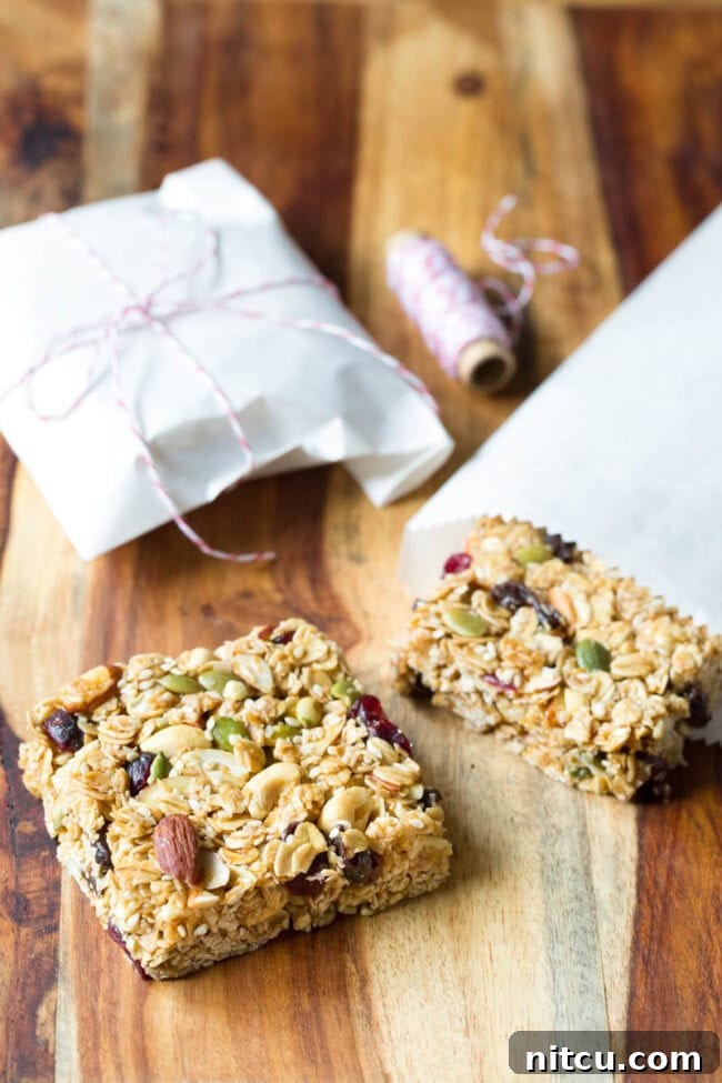 Homemade granola bars on a wooden cutting board.