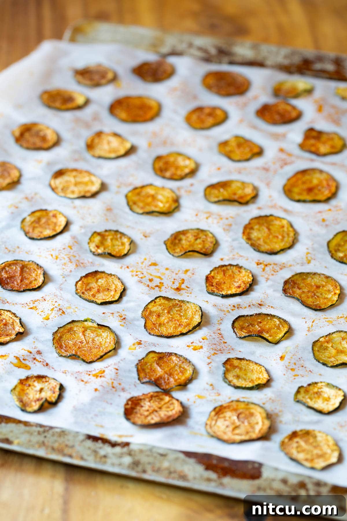 Oven Baked Zucchini Chips on cookie sheet with parchment paper
