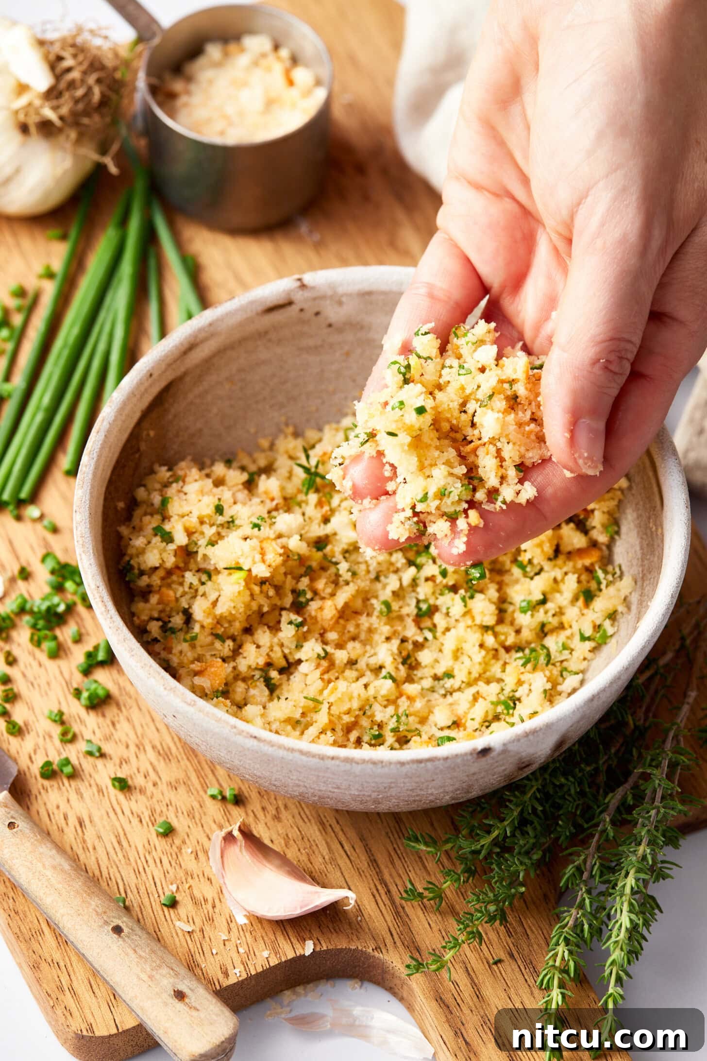 The savory parmesan crust ingredients, including breadcrumbs, cheese, garlic, and herbs, mixed in a bowl, ready to top the salmon.