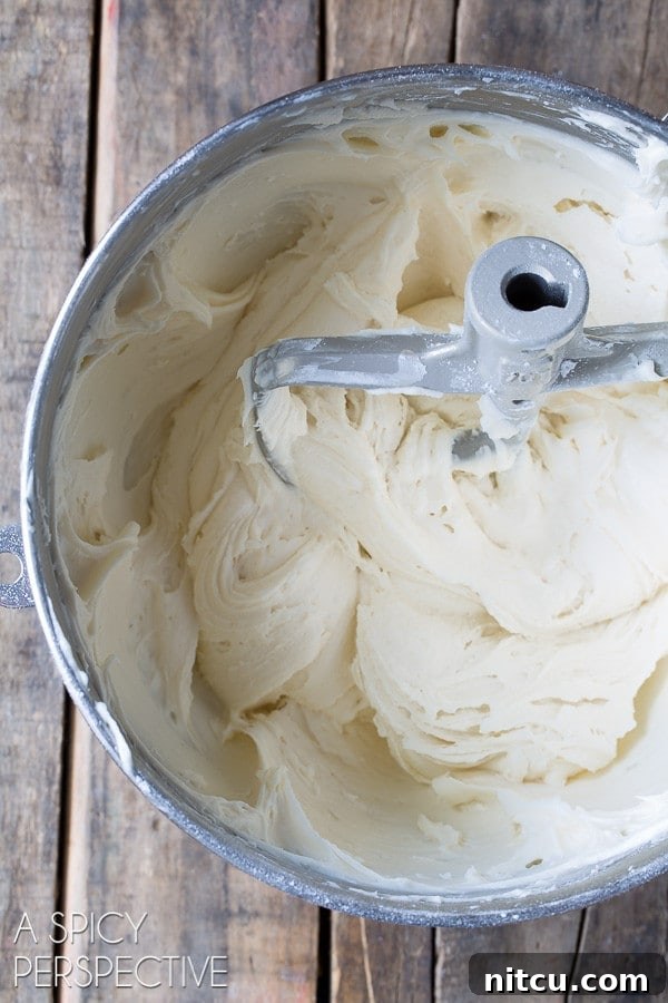 Wet ingredients for Hummingbird cupcakes, including mashed bananas and pineapple, blended together in a mixing bowl.