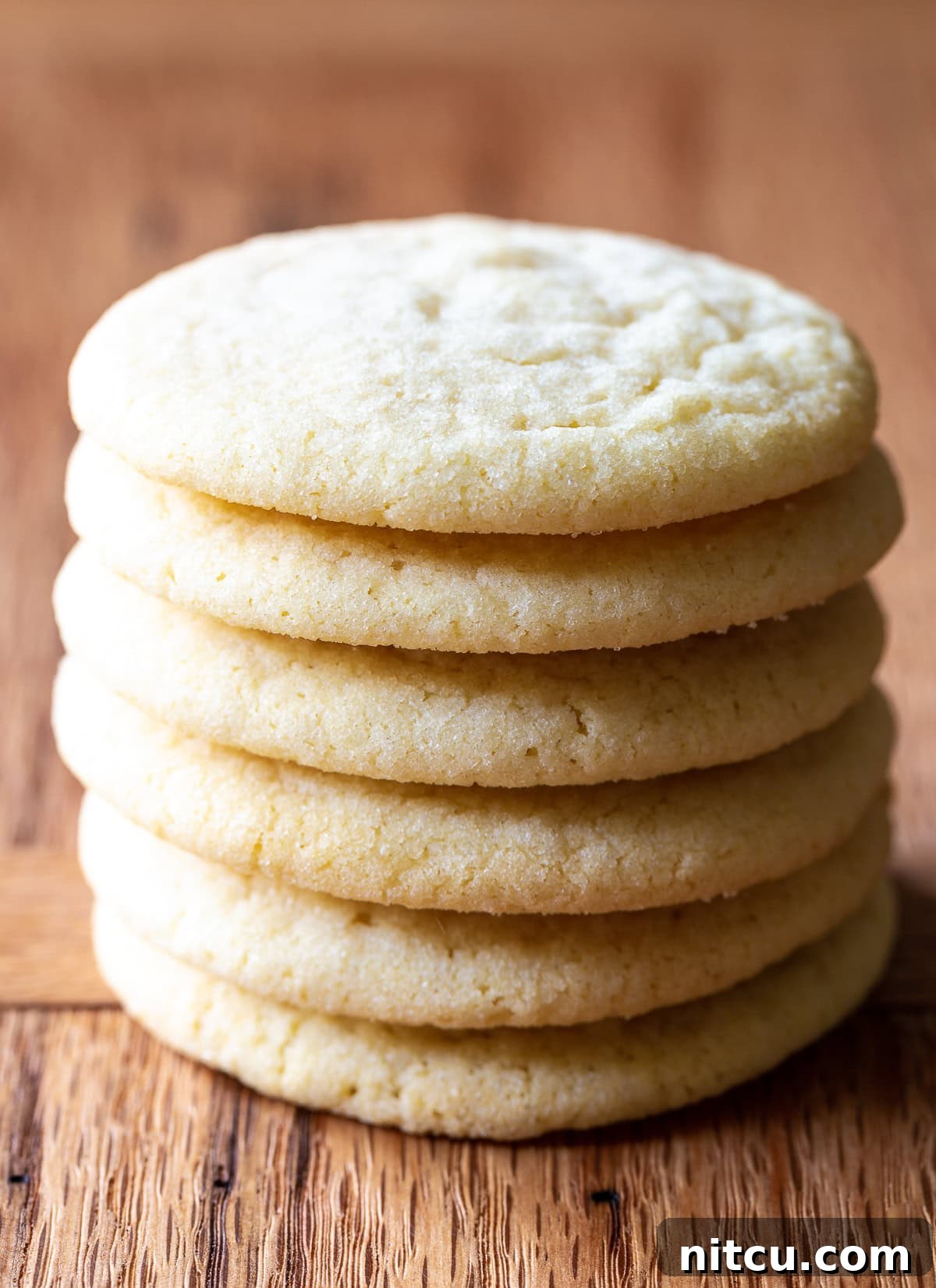 Side view of a stack of the best sugar cookie recipe, showcasing their perfect texture and golden edges.