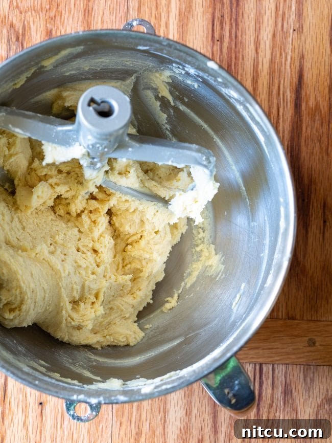 Top view of mixing bowl with raw dough ready for baking these homemade sugar cookies, highlighting the creamy texture.