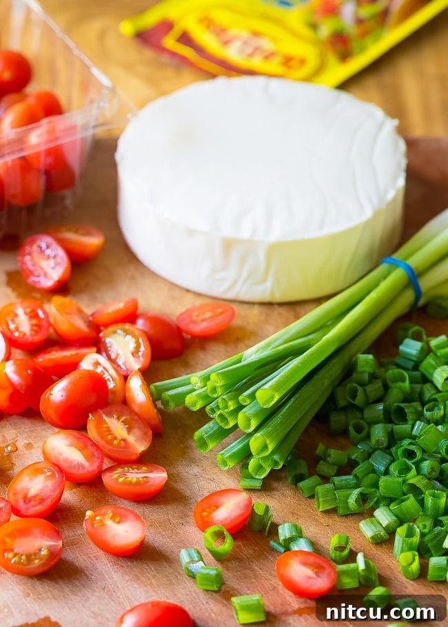 Ingredients needed for grilled chicken salad recipe. These include scallions, grape tomatoes, cheese and fajita seasoning. 