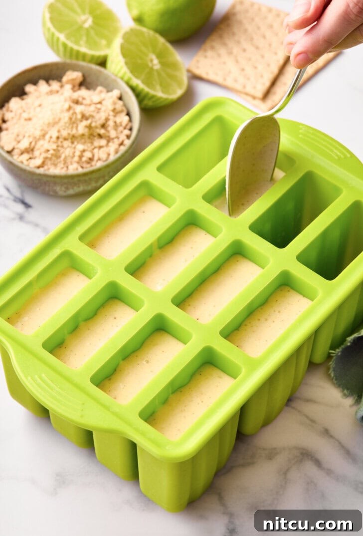 Lime Pudding Popsicles - lime mixture going into popsicle molds