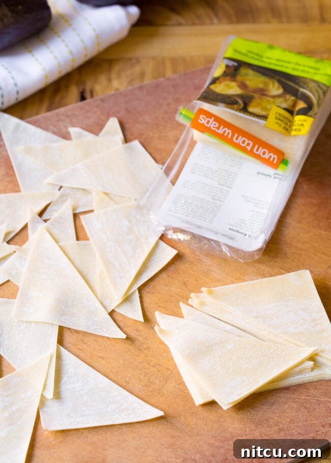 Piles of raw wonton triangles.