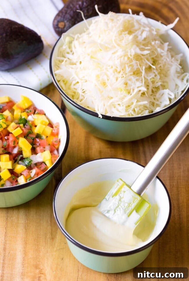 Stirring wasabi mayo in a small bowl with a rubber spatula.