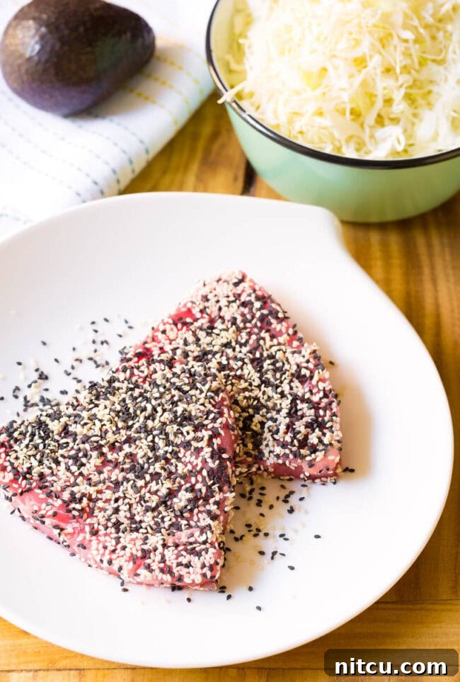 Two raw ahi tuna steak coated with sesame seeds.