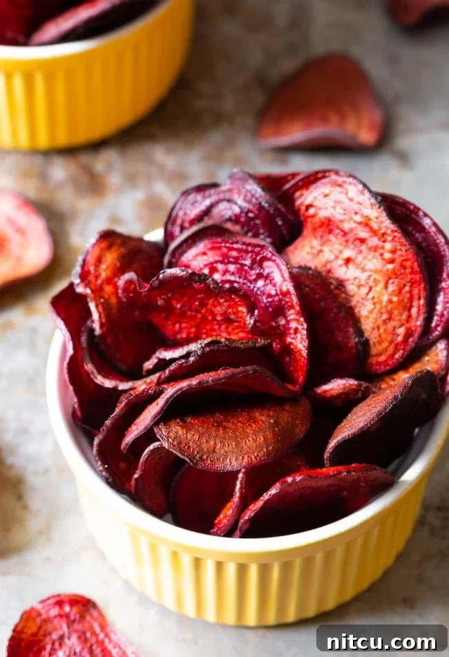 Top view of beet chips in a yellow ramekin. A perfect healthy snack.
