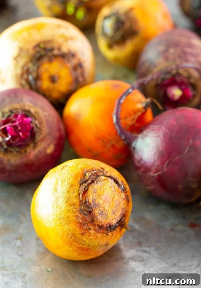 A few different types of beets on a metal surface. Ready for slicing.