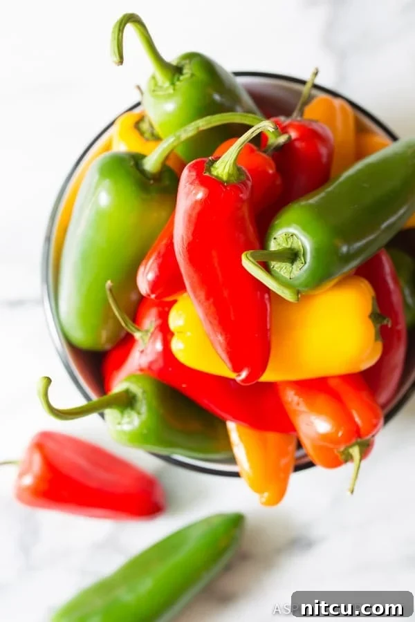 Making 3-Ingredient Mini Stuffed Peppers Recipe on ASpicyPerspective.com - So good! 