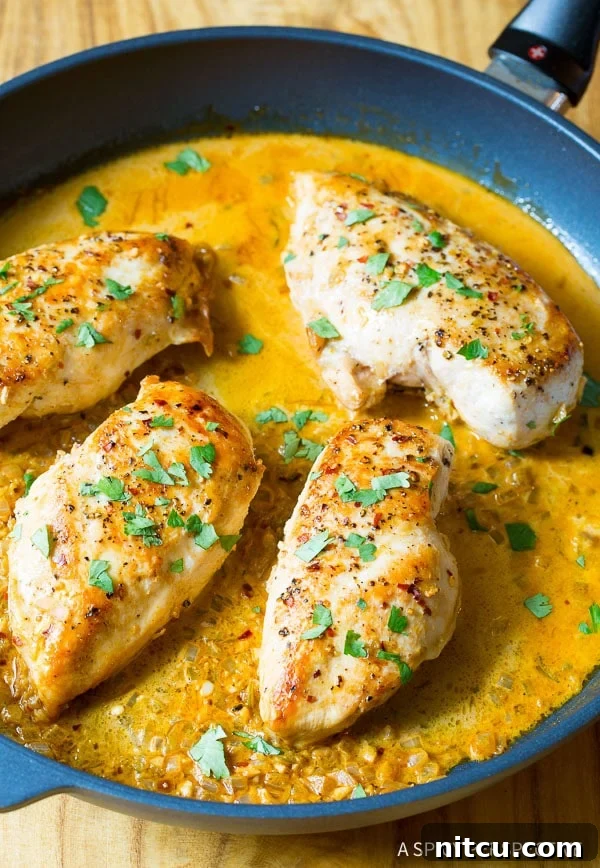 Top down view of garlic lime chicken in a skillet, garnished with fresh cilantro.