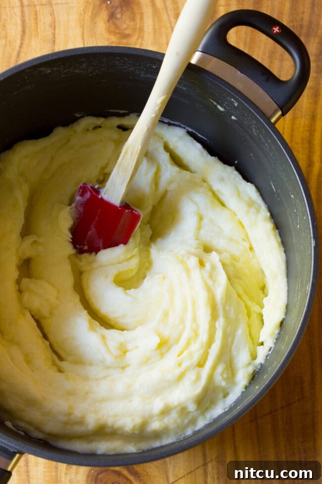 Top view of freshly mashed potatoes in large pot
