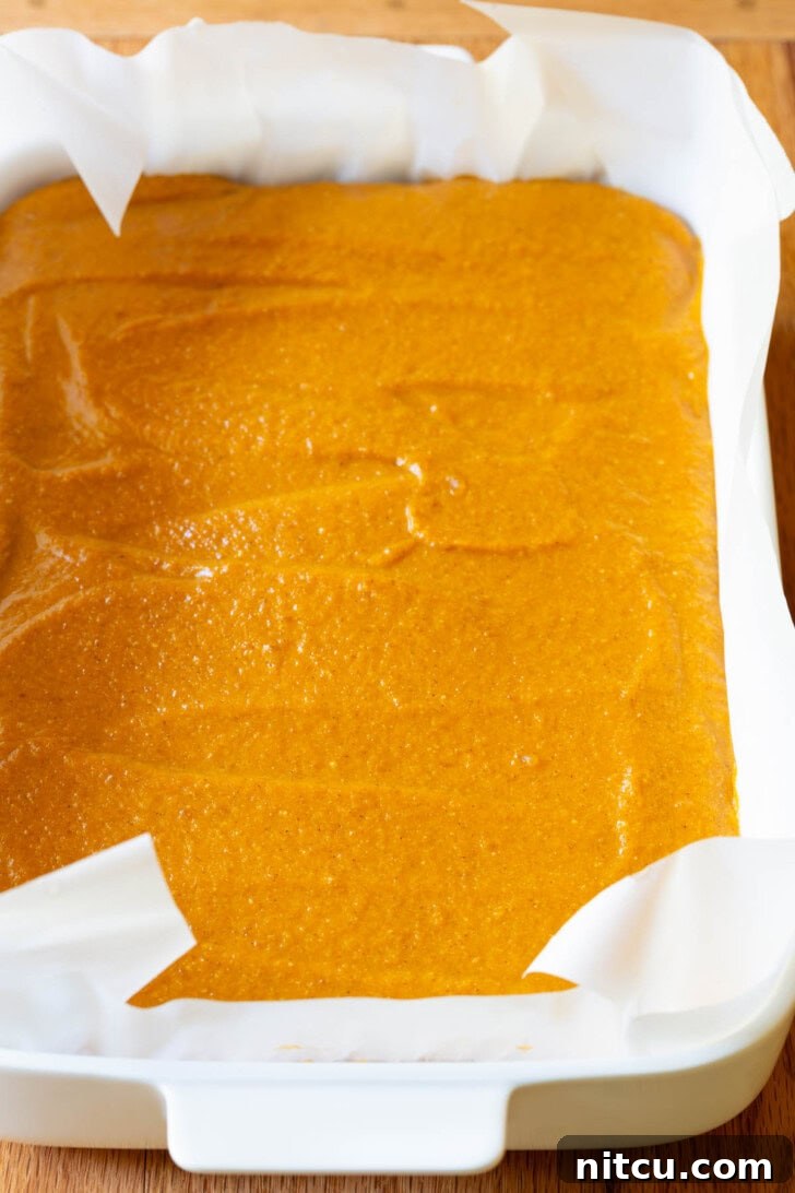 The smooth, evenly spread pumpkin layer, ready for chilling.