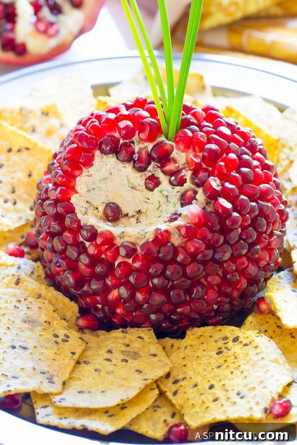 Pomegranate Jeweled Cheeseball  - portion scooped out to expose soft cheese
