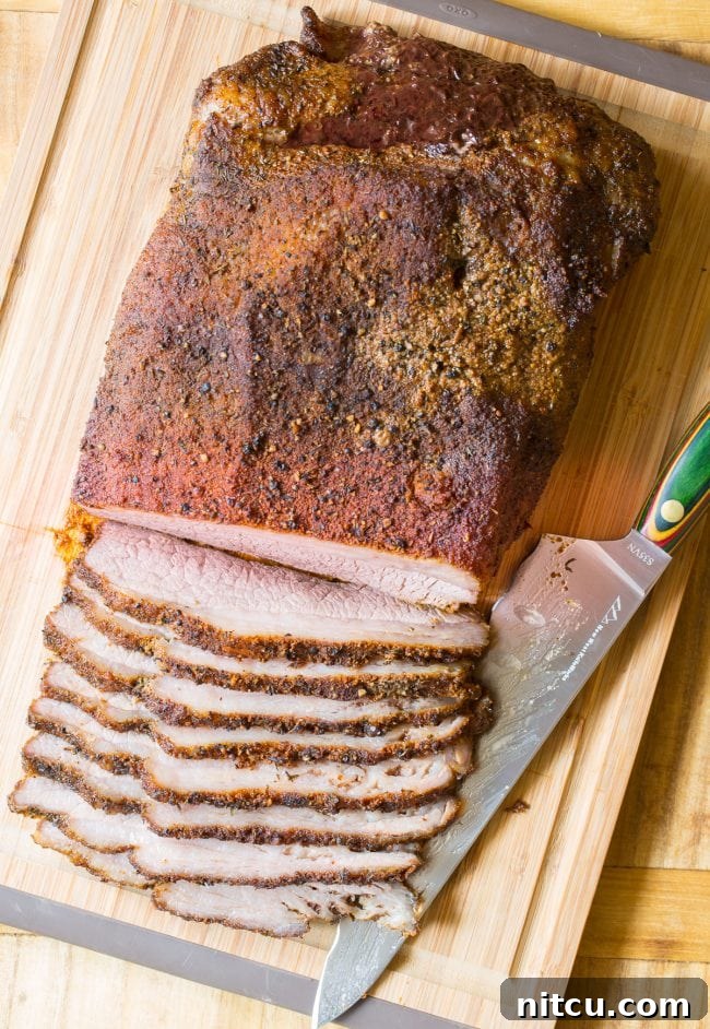 Texas beef brisket sliced against the grain on a cutting board. 
