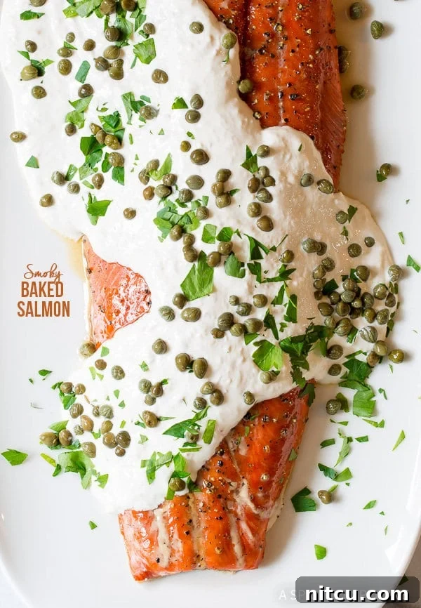 Baked salmon covered in creamy horseradish sauce, fresh capers, and aromatic herbs.