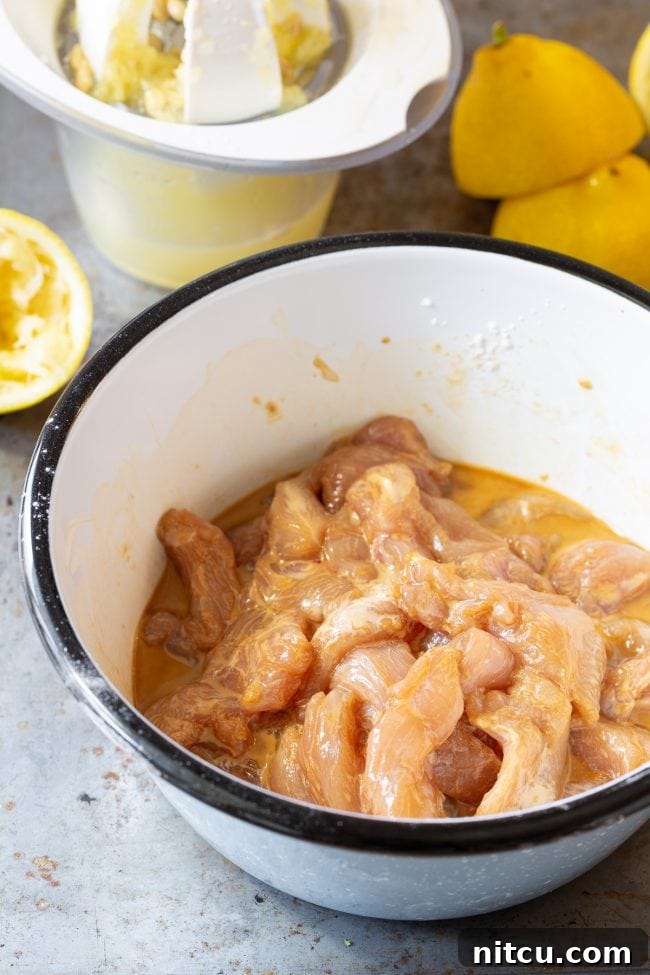 Crispy paleo lemon chicken breast pieces coated in a flavorful sauce.
