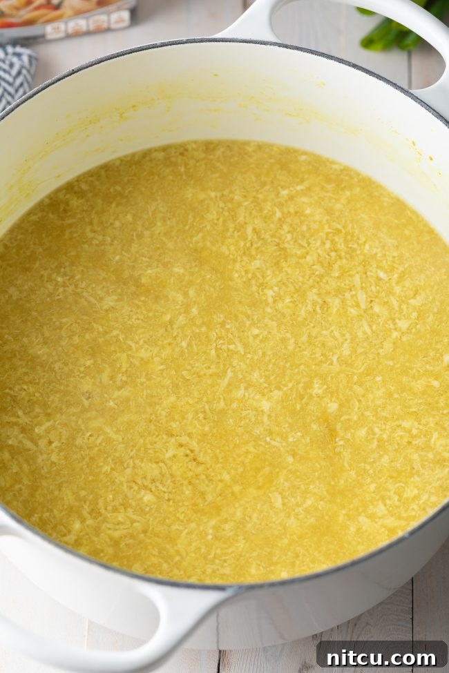 Large pot of soup with ribbons of eggs.