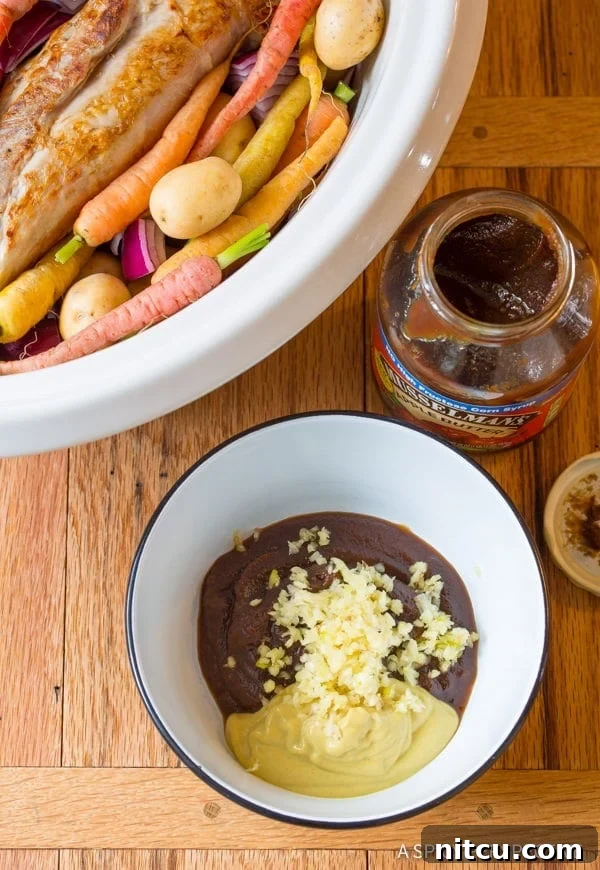 Zesty sauce made with mustard, apple butter, and herbs, ready to be poured
