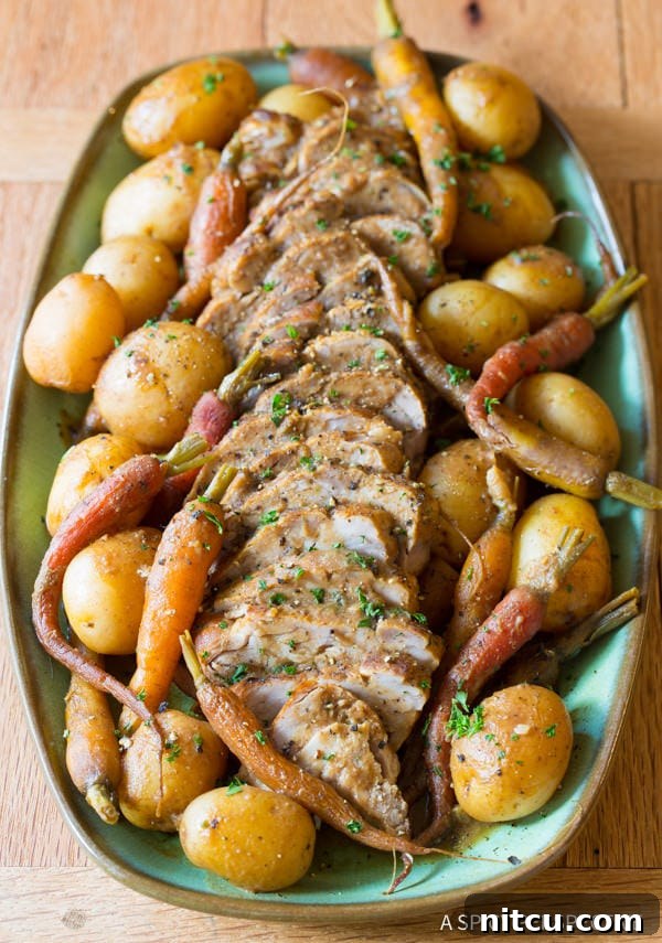 Crockpot Pork Loin with Vegetables served on a platter with potatoes, carrots, and onions