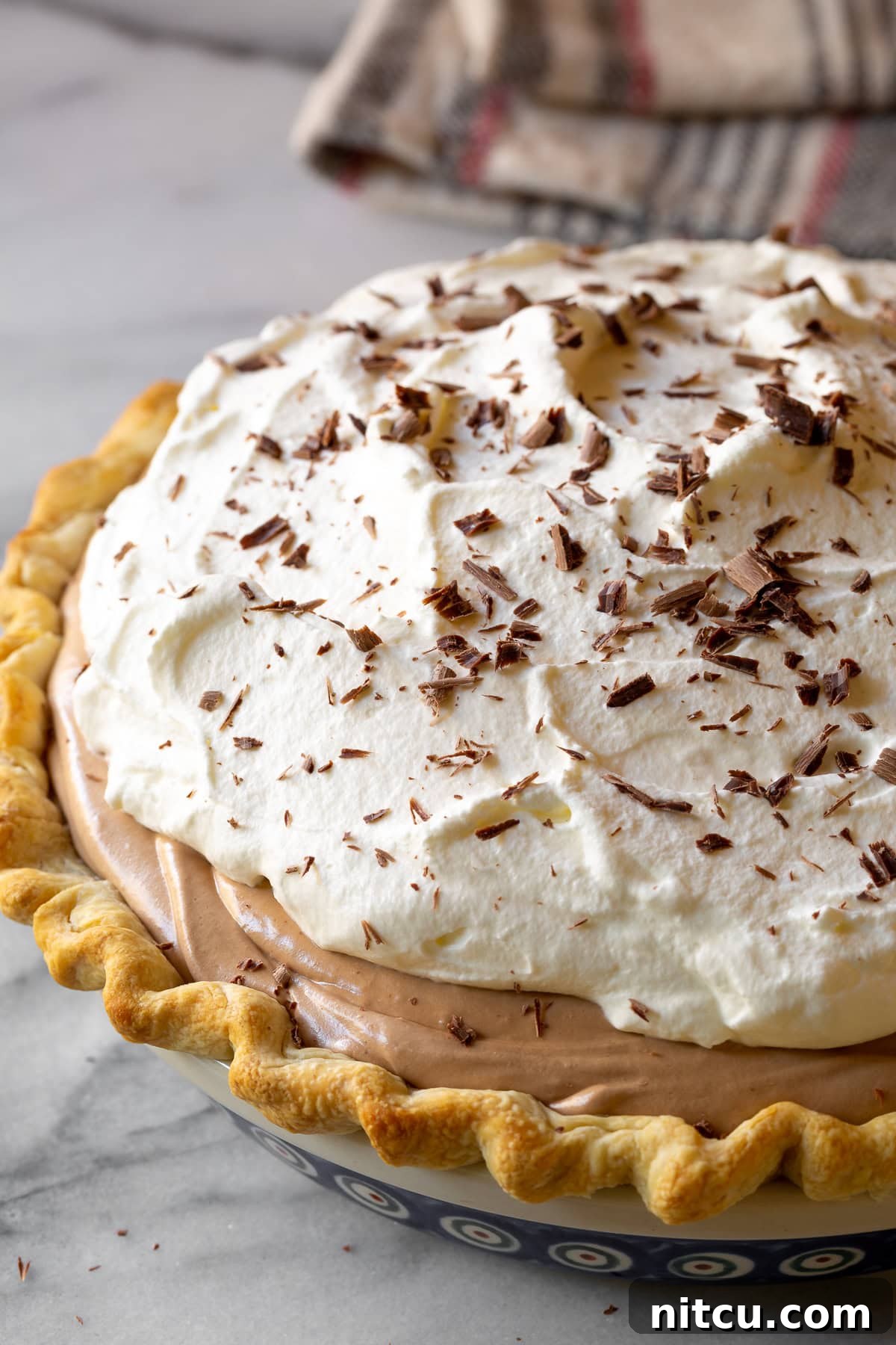 Close-up of the finished French Silk Pie, beautifully garnished with delicate chocolate shavings.
