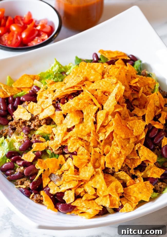 Crumbled Nacho Cheese Doritos in a bowl, showing their iconic texture.