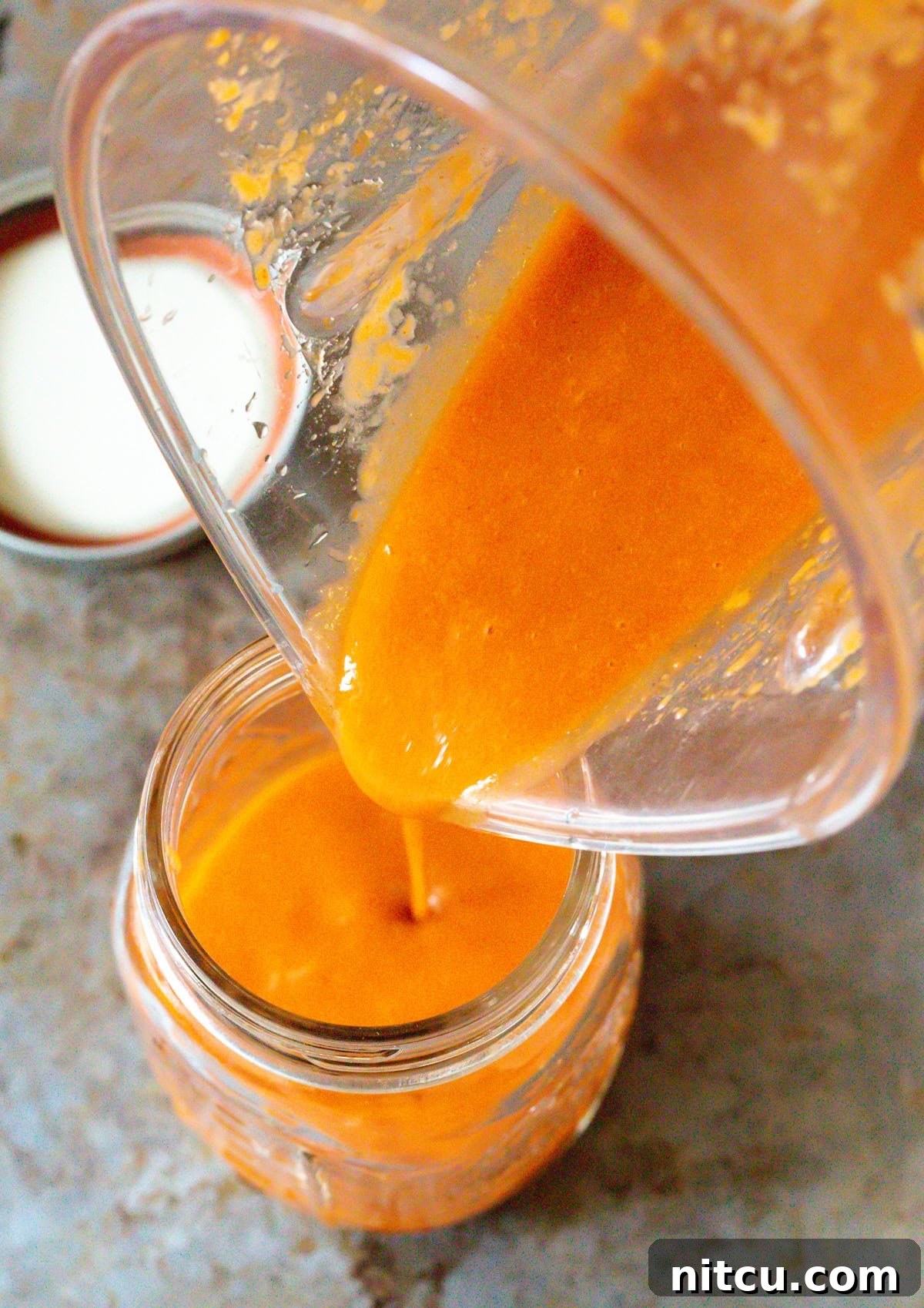 Pouring catalina salad dressing into jars