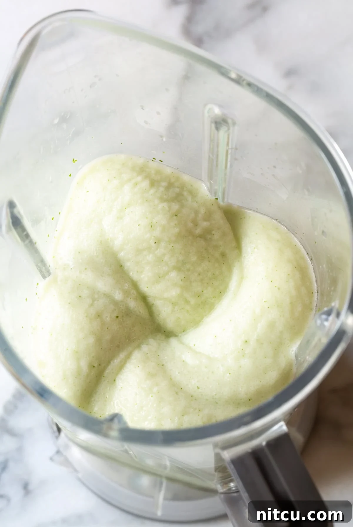 Refreshing Coconut Mojito garnished with mint and lime