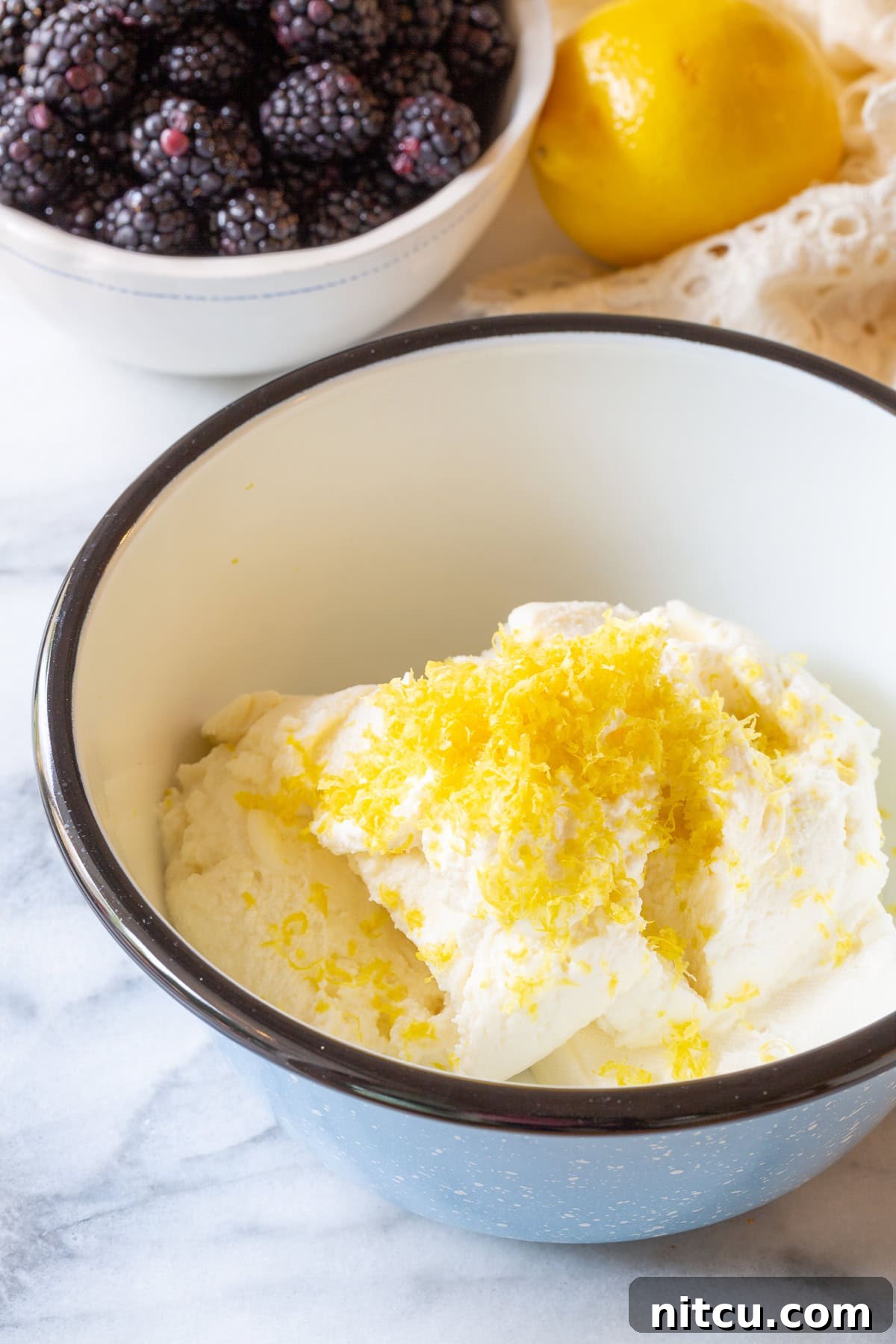 Ingredients for sweet ricotta cream in a mixing bowl, ready for blending