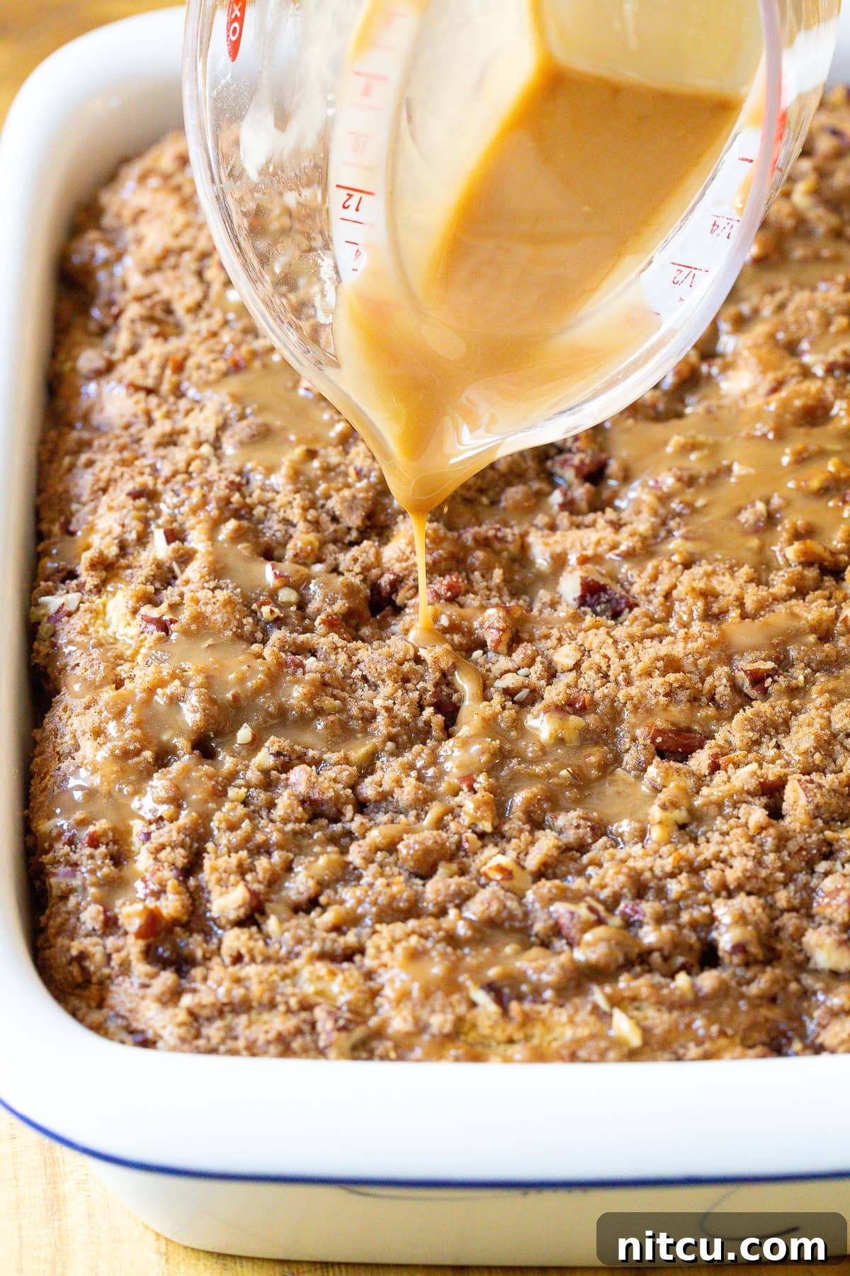 Easy Coffee Cake Recipe with kahlua drizzle over the crumble top, a close-up of the delicious glaze