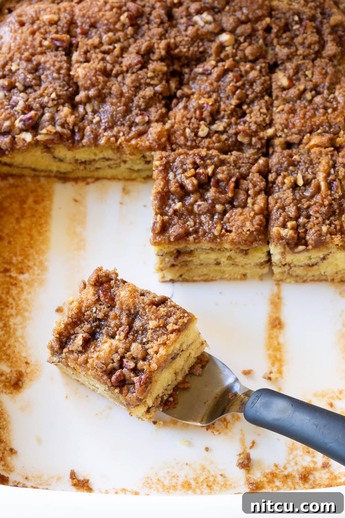 Kahlua Coffee Cake - cut into squares with layers showing - on piece on spatula ready to lift, enticingly moist