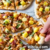 Grilled Chicken Teriyaki Pizza with pineapple and bacon, presented on a plate.