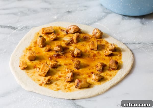 How to Make Grilled Chicken Teriyaki Pizza with toppings arranged on dough.