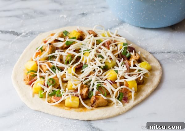 Make the Best Grilled Chicken Teriyaki Pizza as it cooks on the grill stone.