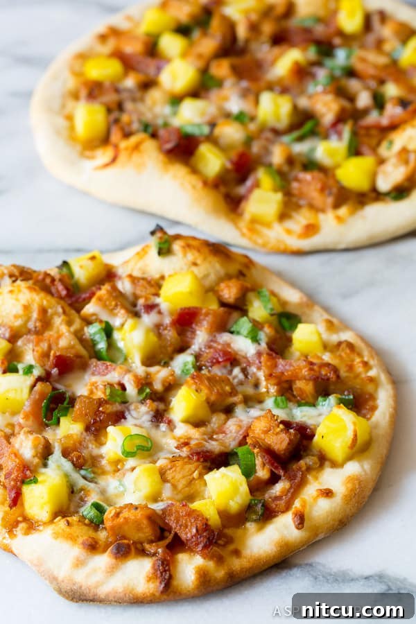 Teriyaki Pizza with chicken and pineapple, close up shot, highlighting the melty cheese and toppings.