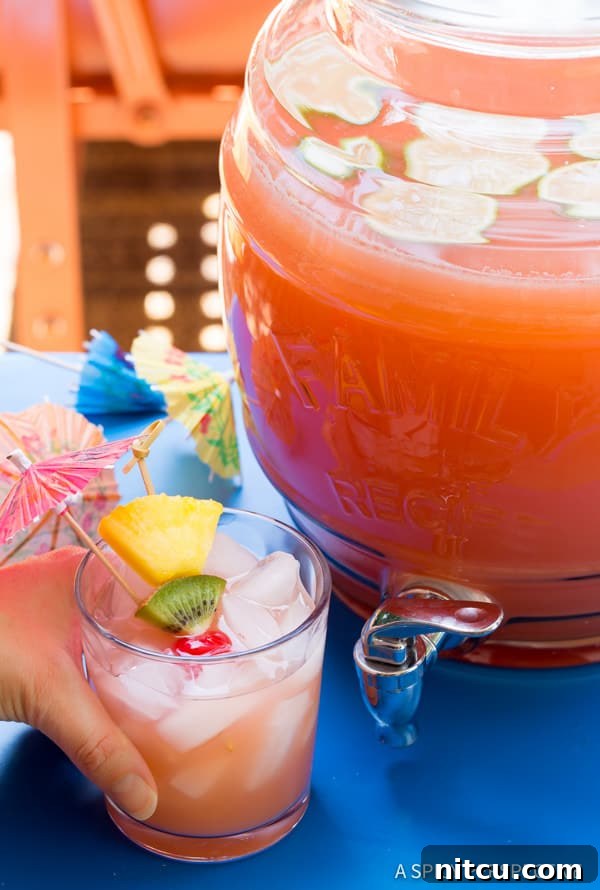 Hand holding a glass of Party Punch Recipe with Rum