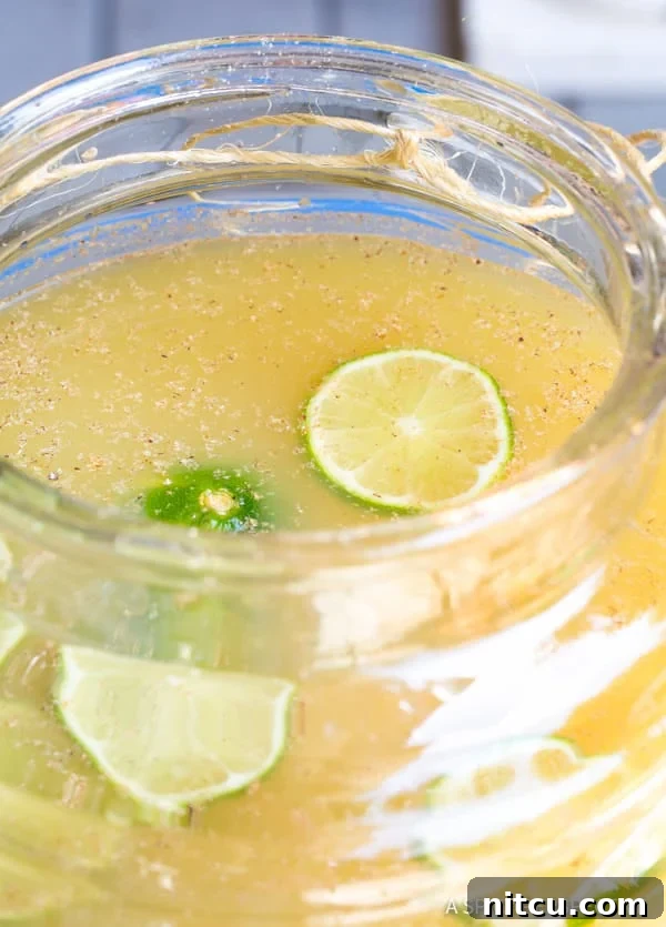 Simple and sparkling Stormy Donkey Party Punch, garnished with fresh fruit, ideal for any large celebration.