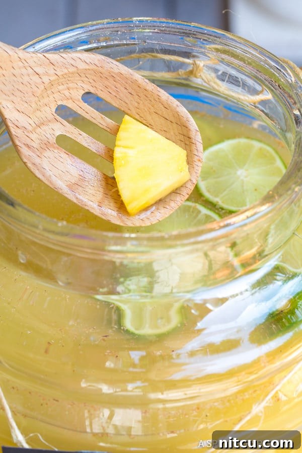 Delicious Stormy Donkey Party Punch with lime and ginger slices, highlighting its refreshing and spicy notes.