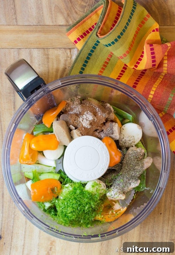 Ingredients for making healthy Jamaican Jerk Chicken Thighs marinade in a food processor